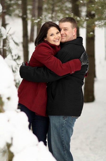 couple smiling in woods