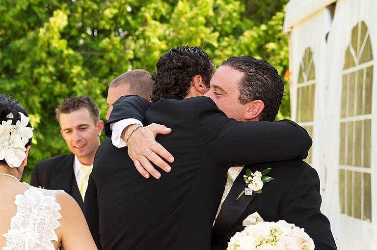 Groom hugs groomsman at Caledon wedding at Royal Ambassador
