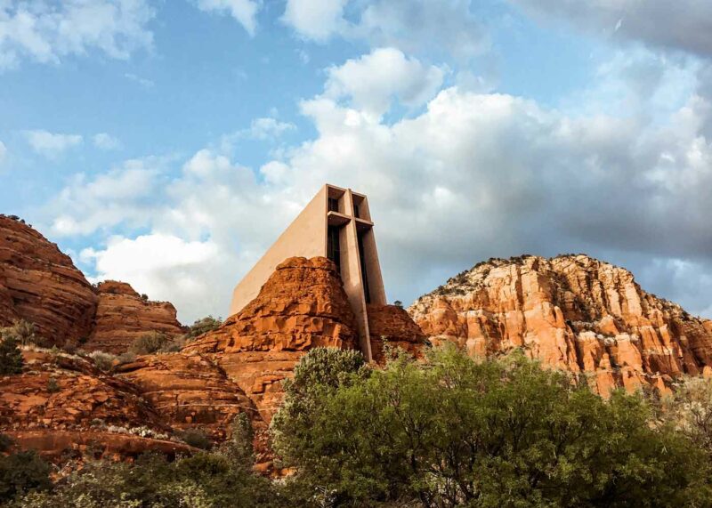 bride on hood of cherry red vintage thunderbird