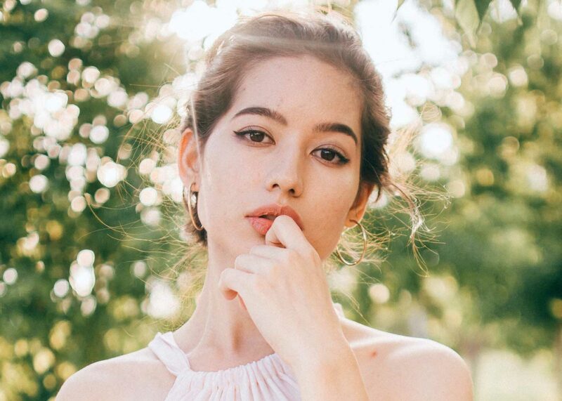 bride on hood of cherry red vintage thunderbird
