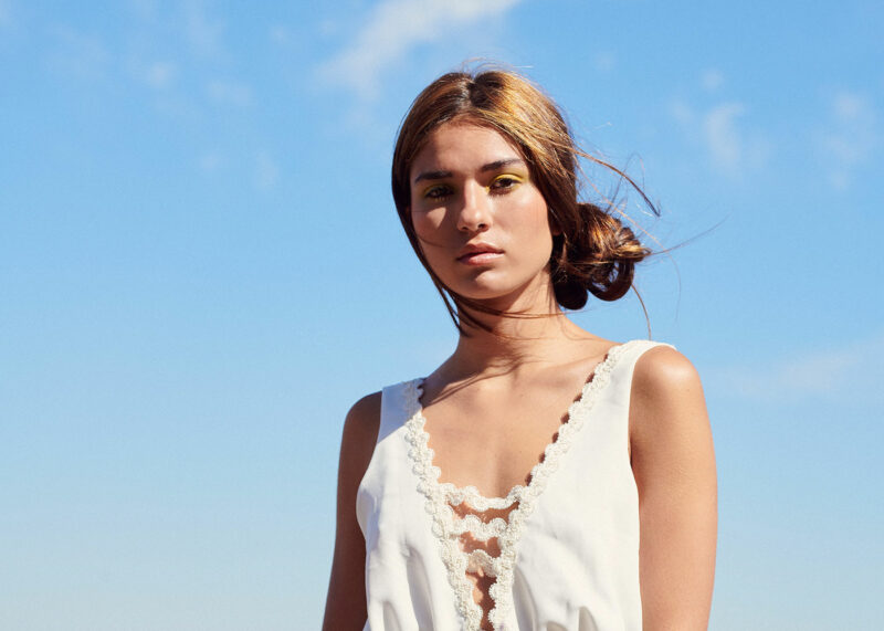 bride on hood of cherry red vintage thunderbird