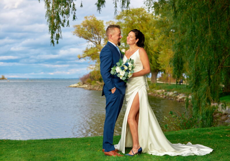 Handsome groom and beautiful bride by Georgian Bay at Bear Estate wedding in Collingwood