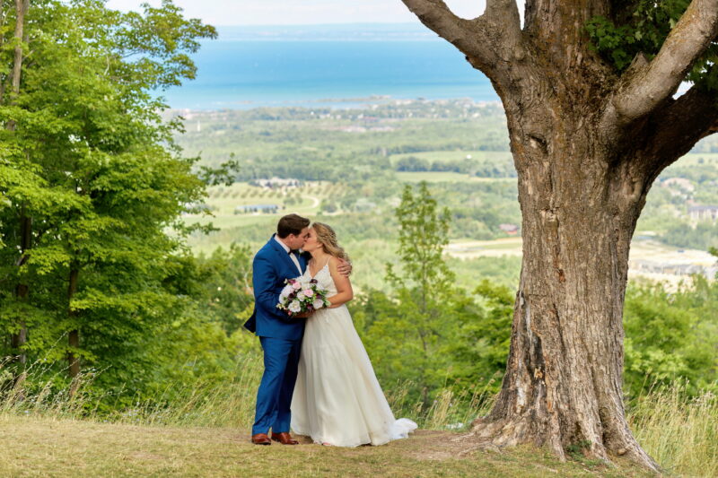 Bride and Groom Kissing at the Top of Blue Mountain
