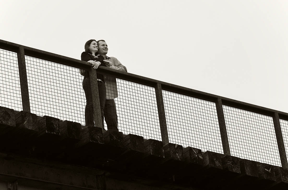 Young couple on trestle bridge at Orange corners engagement session near Omemee, Lindsay, and Peterborough