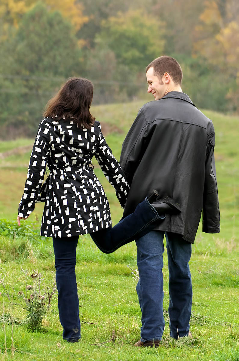 girl gives fiance a playful tap during country engagement session near Peterbrough, ON