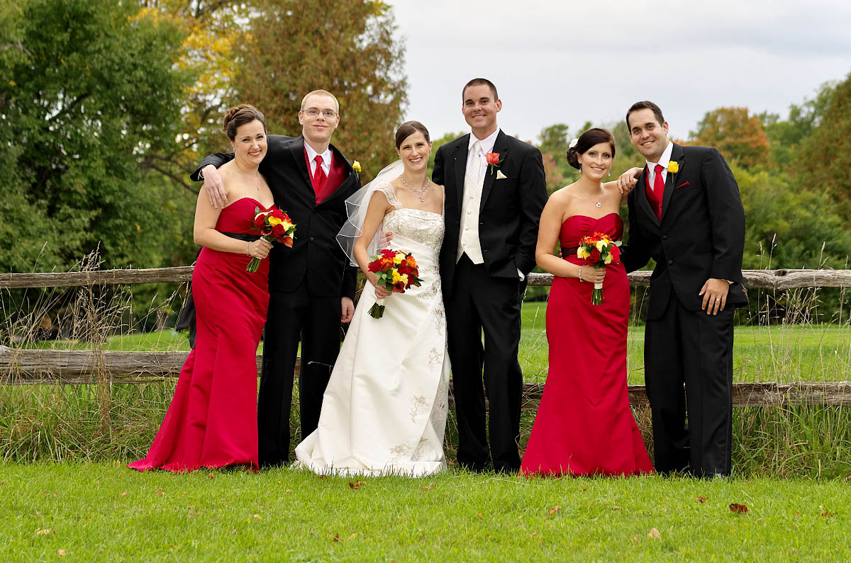 wedding party by split rail fence at Eganridge Golf Club wedding