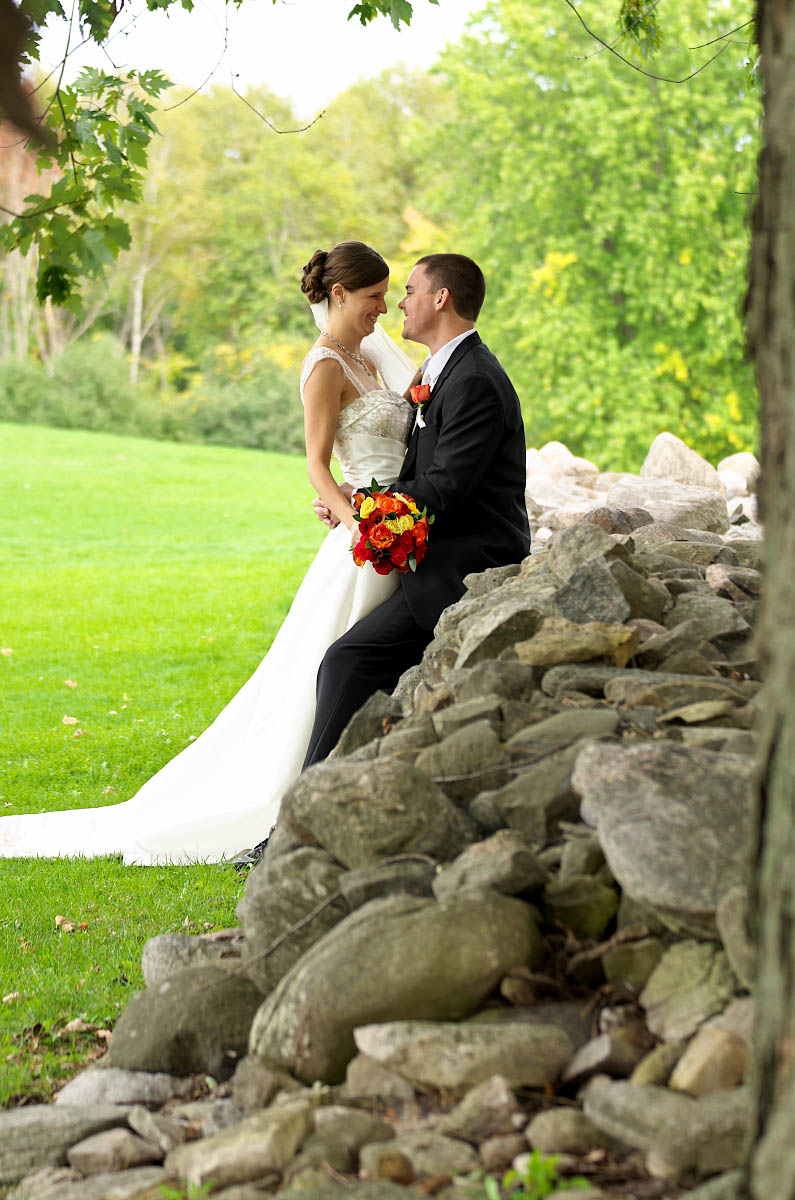 Wedding couple wiith bouquet and old stone wall at Eganridge wedding