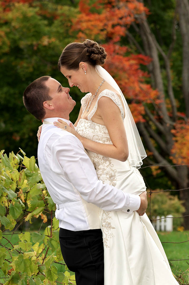 Groom lifts his bride in his arms at Eganridge wedding