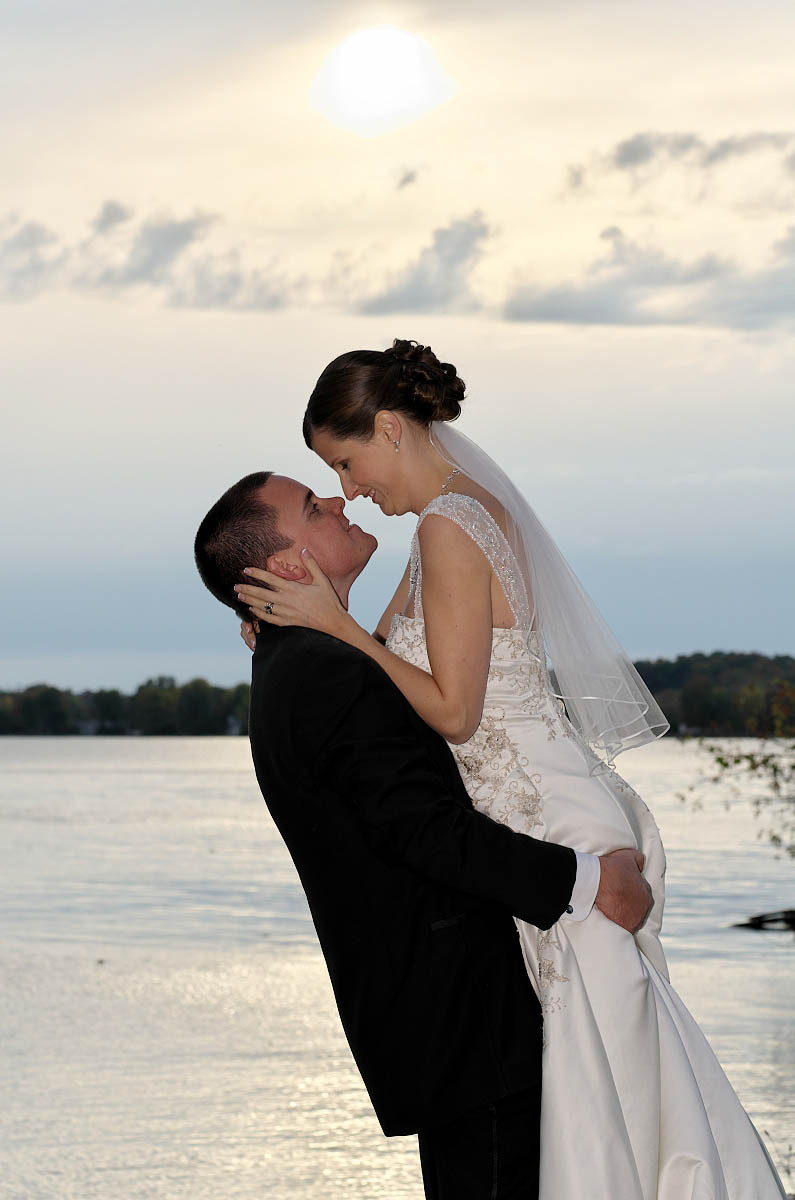 Groom lifts his bride in his arms at Eganridge wedding