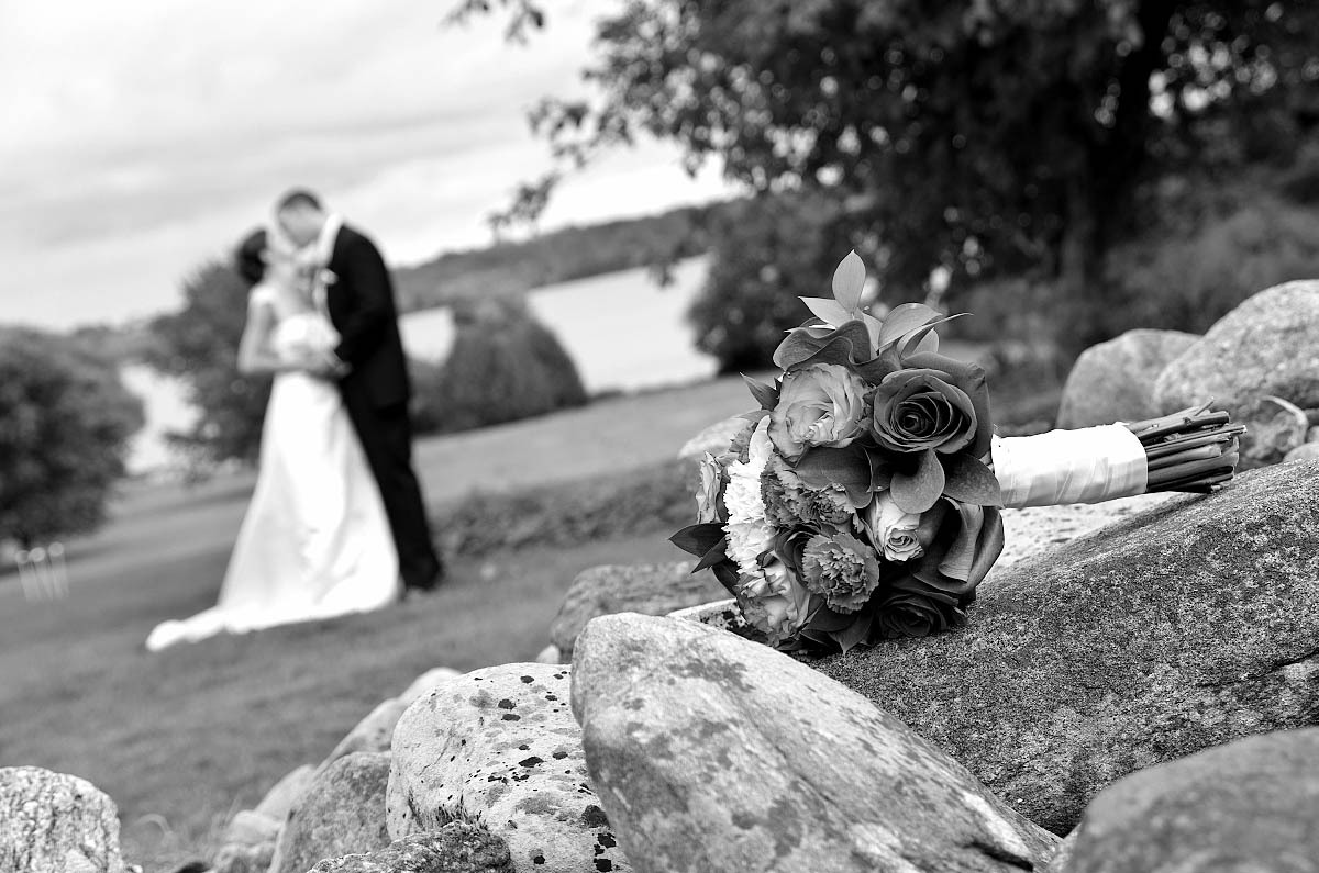Wedding couple wiith bouquet and old stone wall at Eganridge wedding