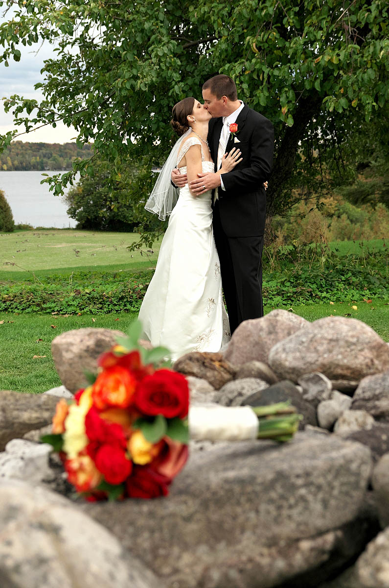 Wedding couple wiith bouquet and old stone wall at Eganridge wedding