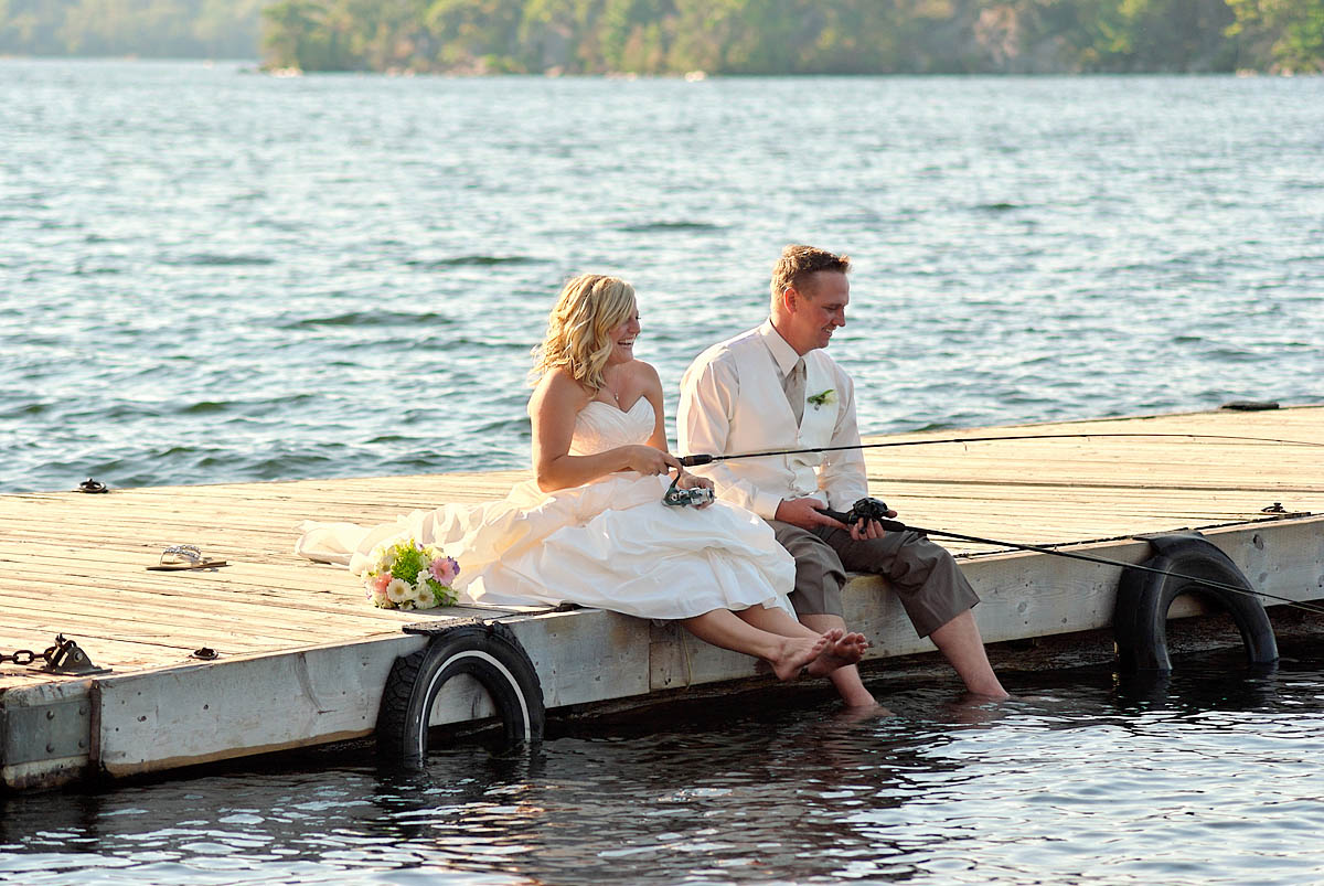 wedding couple fishing on docks at irwin inn wedding near lakefield