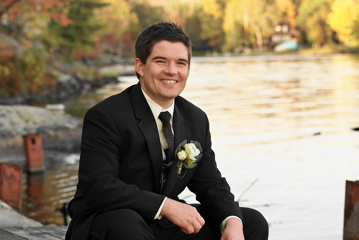 groom by stoney lake at viamede resort wedding