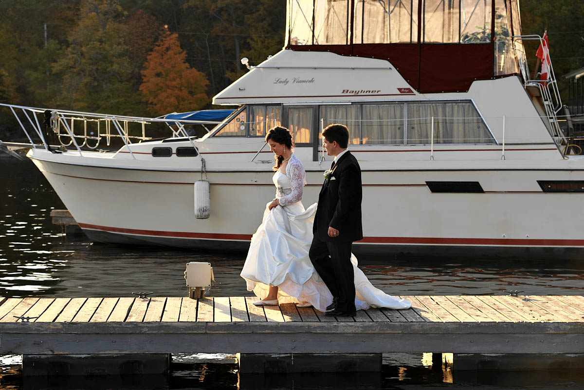bride and groom on dock at viamede resort wedding