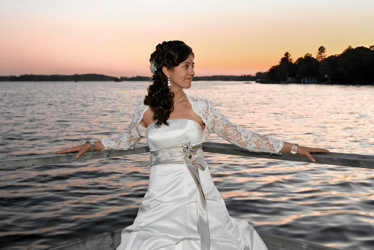 bride on dock at night at viamede resort wedding
