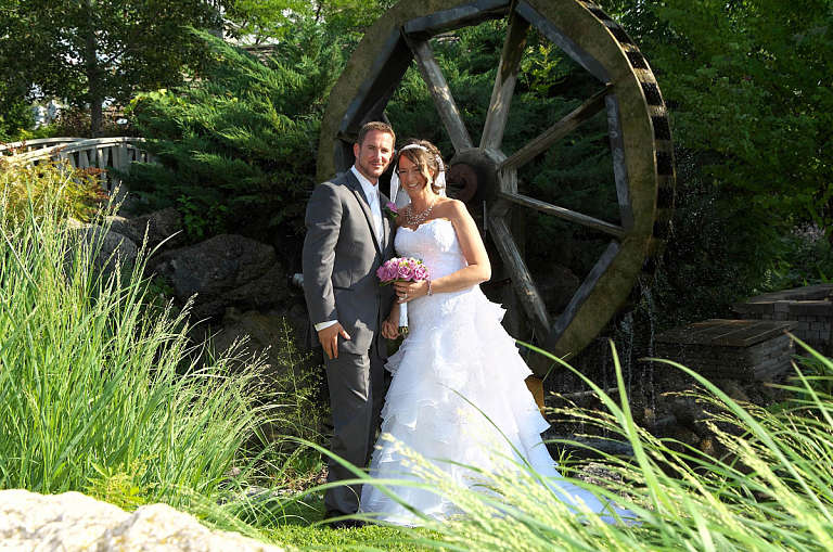 bride and groom by waterwheel nottawasaga