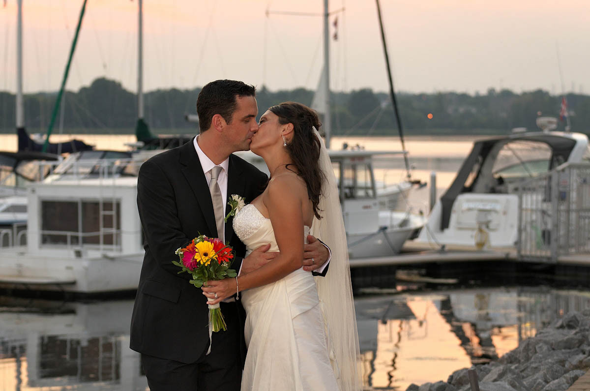 The Lake Hose weding photographer captures couple at sunset by Lake Ontario Yacht Club