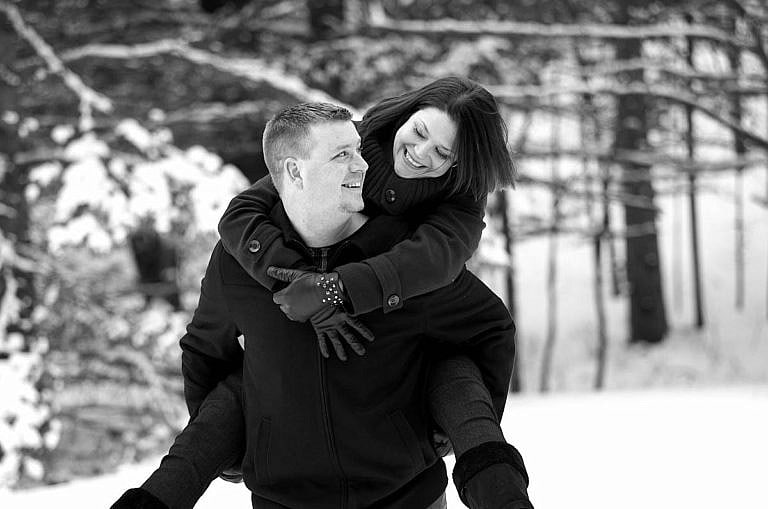 Winter piggyback at Wasaga Beach Provincial Park forest dring Wasaga engagement phtoography session