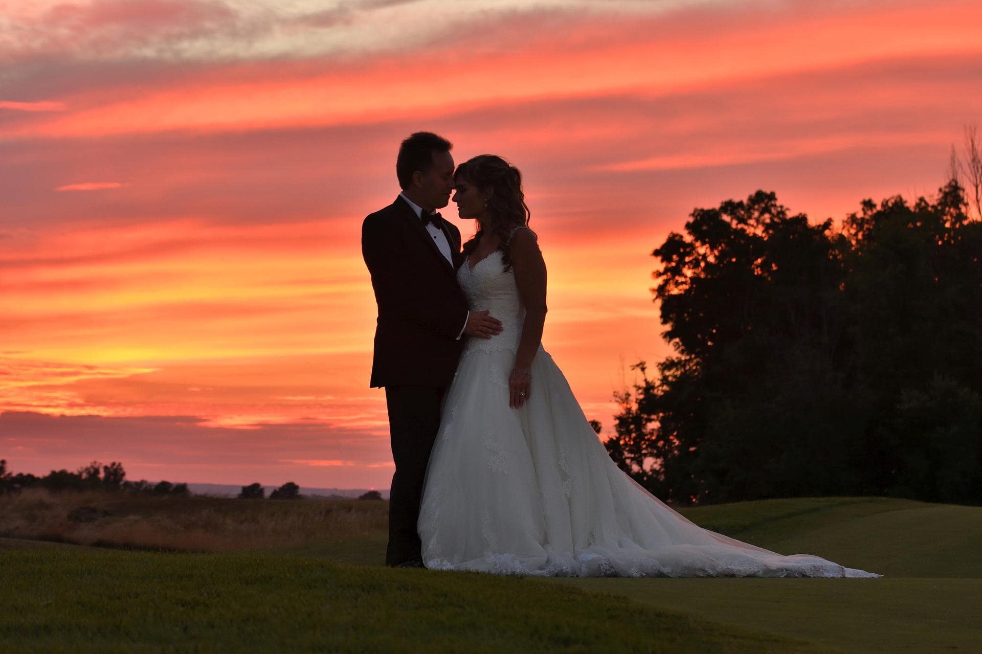 Bride and Groom embrace at sunset at the Club at Bond Head