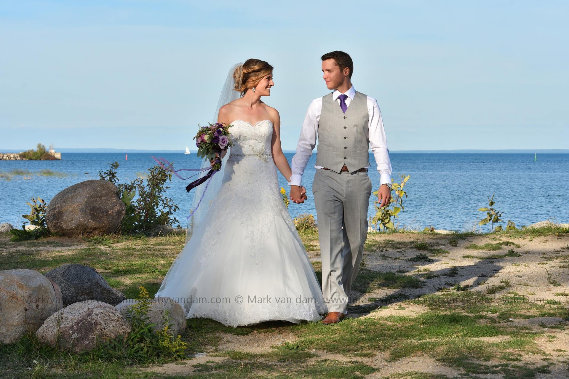 Bride and Groom walk hand in hand at Bear Estate in Collingwood, ON