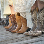 close up of bridesmaids wearing cowboys, standing on dock