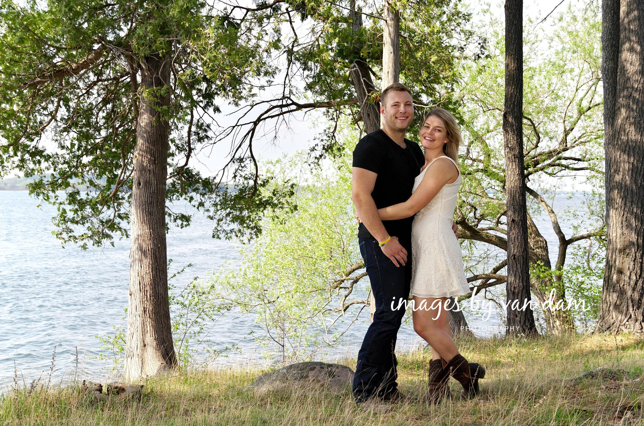 Country themed engagement session on grassy hill by lake