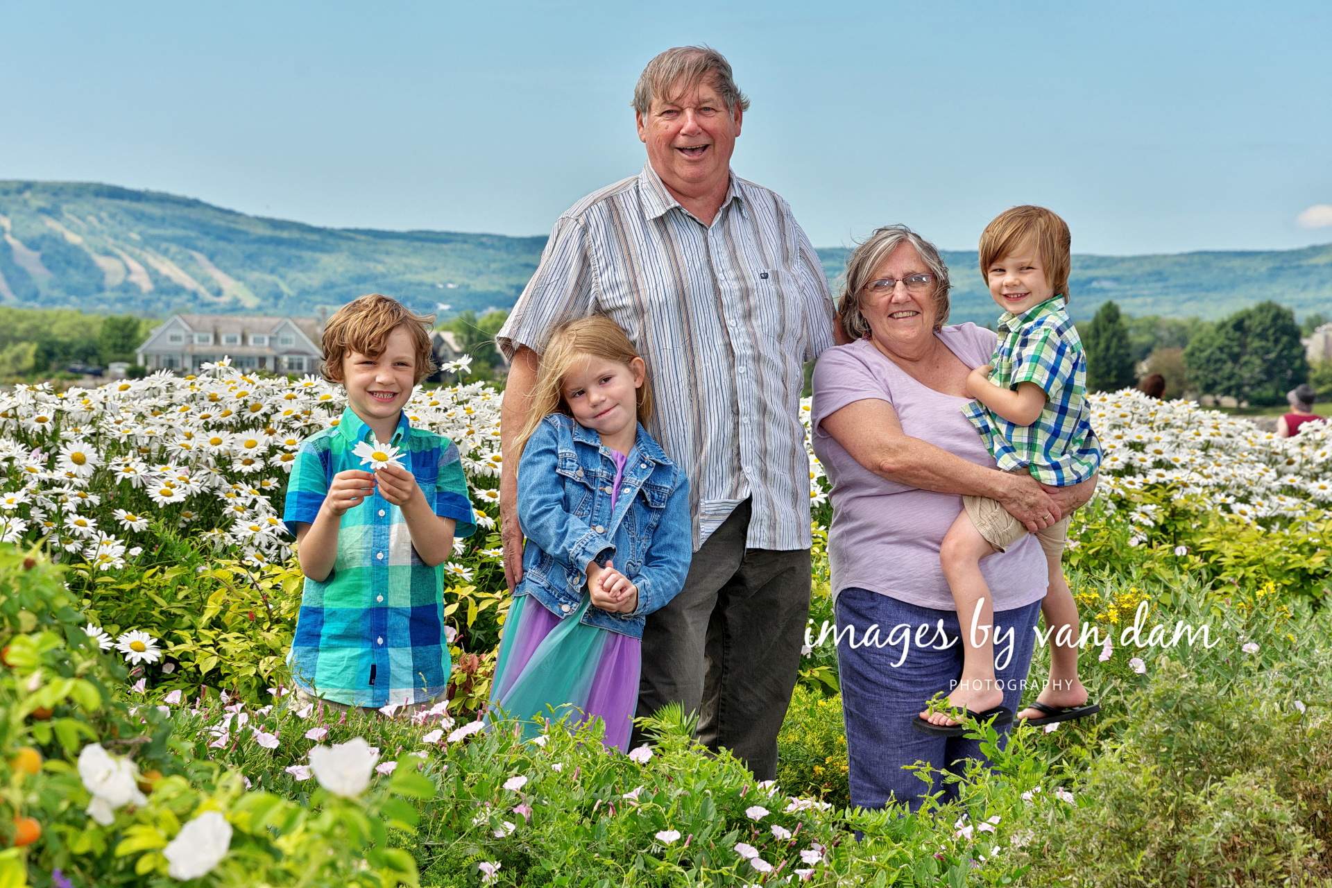 Proud Grandparents pose with their Grandchildren in lush flower garden collingwood family portraits shipyards portraits collingwood photographer