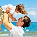 A young father lifts his Jubilant Son at a Collingwood Portrait Session