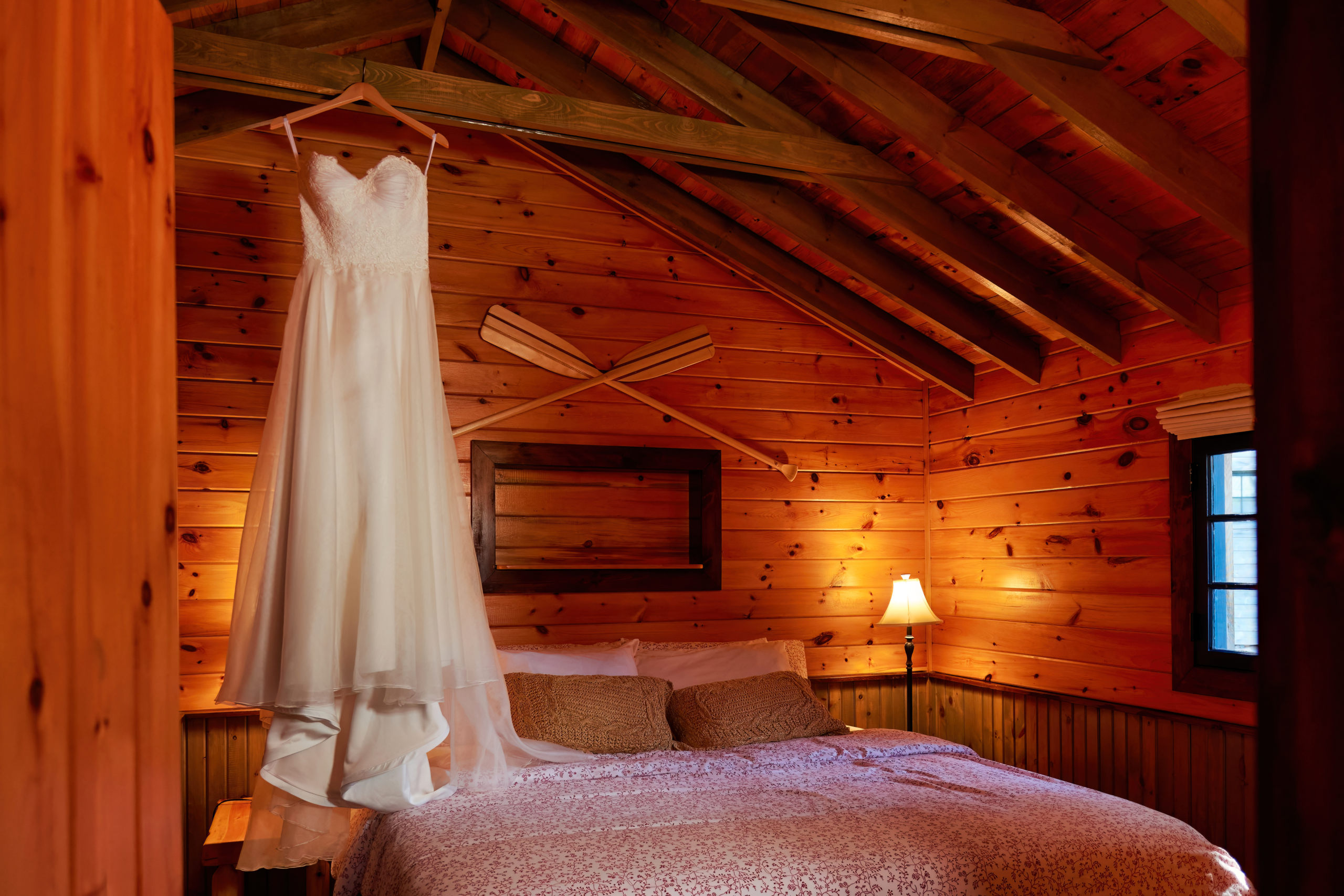 Wedding Dress Hanging in Rustic Cabin at The Lodge at Pine Cove in French River, Ontario