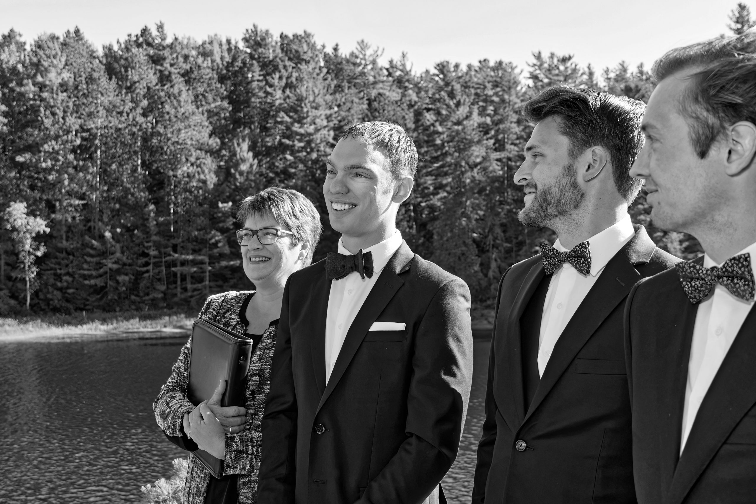 An excited Groom watches his Wife approach at outdoor Wedding Ceremony