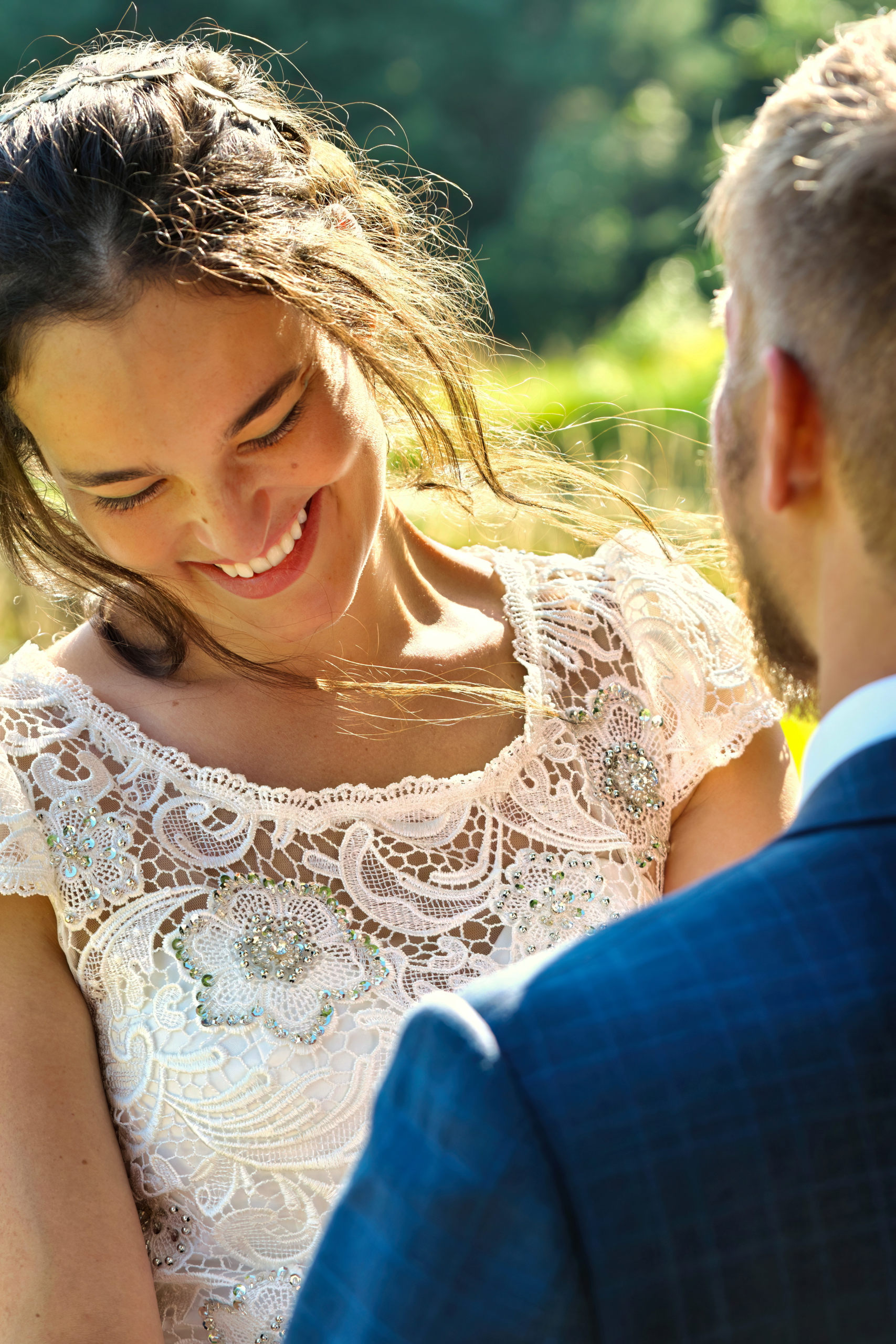 A bride smiles at the groom's speech to her during a Northern Ontario wedding